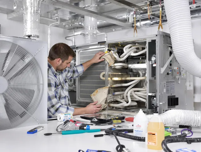 Hanson Air Duct Cleaning specialist performing precision AC coil cleaning in Hanson