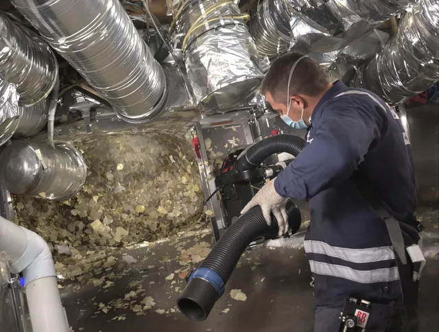 Hanson Air Duct Cleaning specialist operating negative pressure cleaning equipment for thorough duct maintenance in Hanson