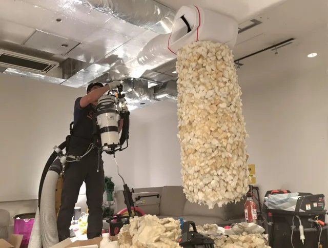 Hanson Air Duct Cleaning technician performing precision vacuum insulation removal in a residential property in Hanson